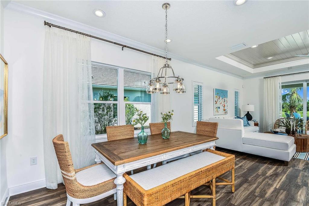 4551 Centaurus Circle Naples, FL 34120 - Photo 5 of 26 a living room with a couch and a chandelier