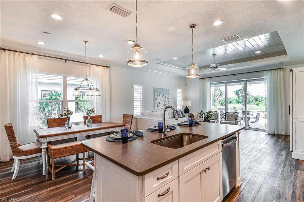 4551 Centaurus Circle Naples, FL 34120 - Photo 8 of 26 a kitchen with counter space a sink appliances and a large window