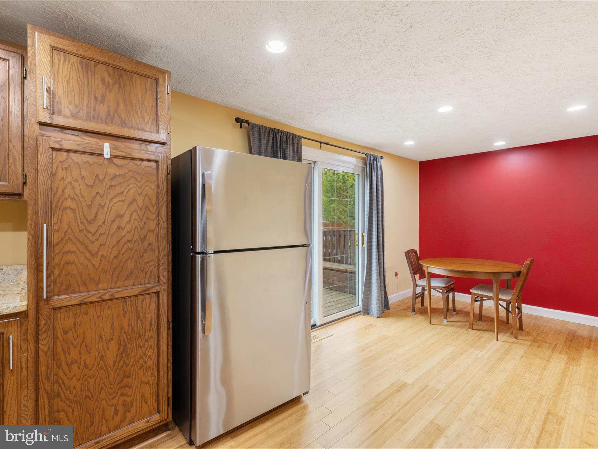 653 Willowby Run Pasadena, MD 21122 - Photo 11 of 31 a view of a refrigerator in kitchen and wooden floor