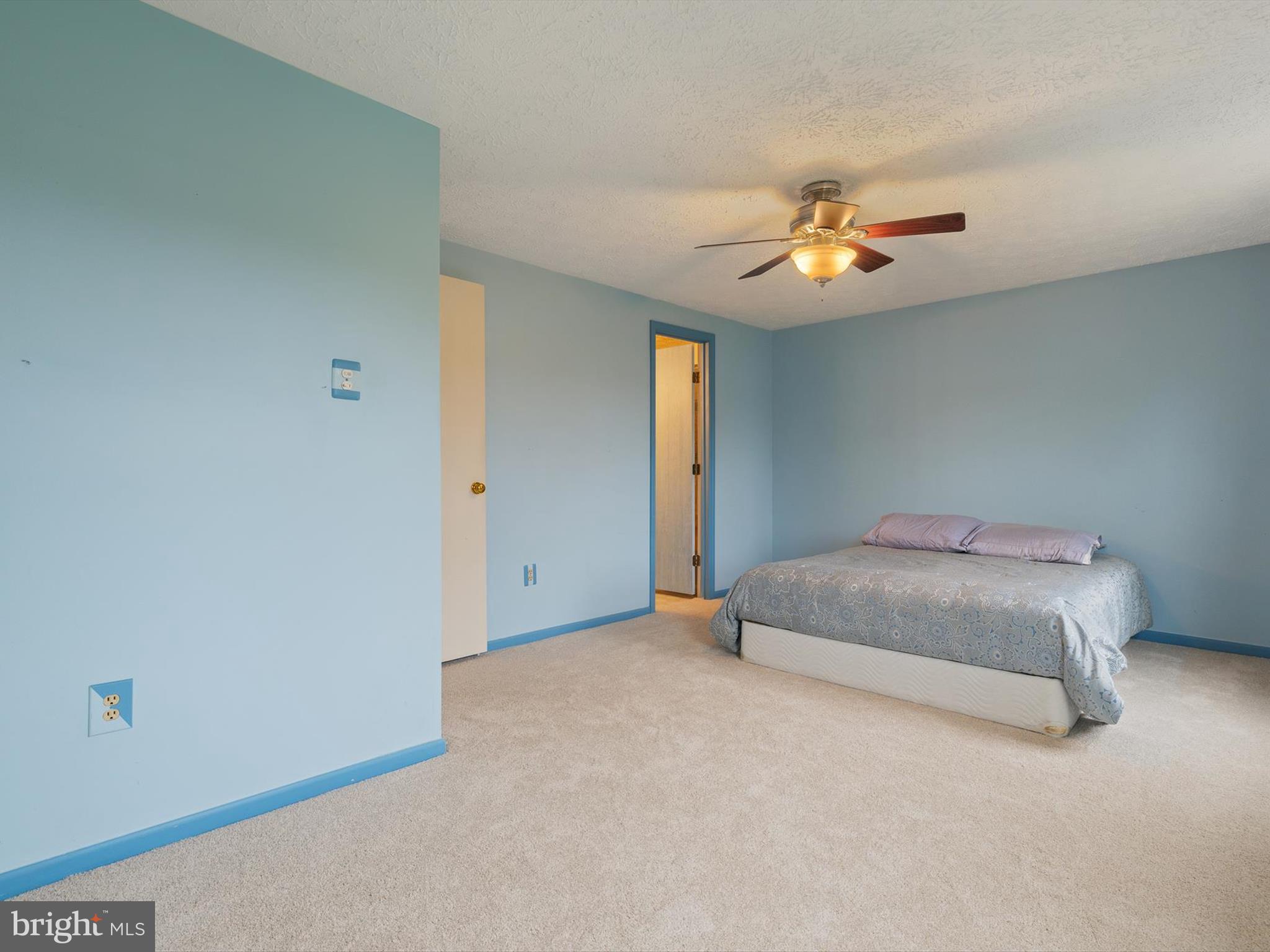 653 Willowby Run Pasadena, MD 21122 - Photo 17 of 31 a bedroom with a bed and a ceiling fan