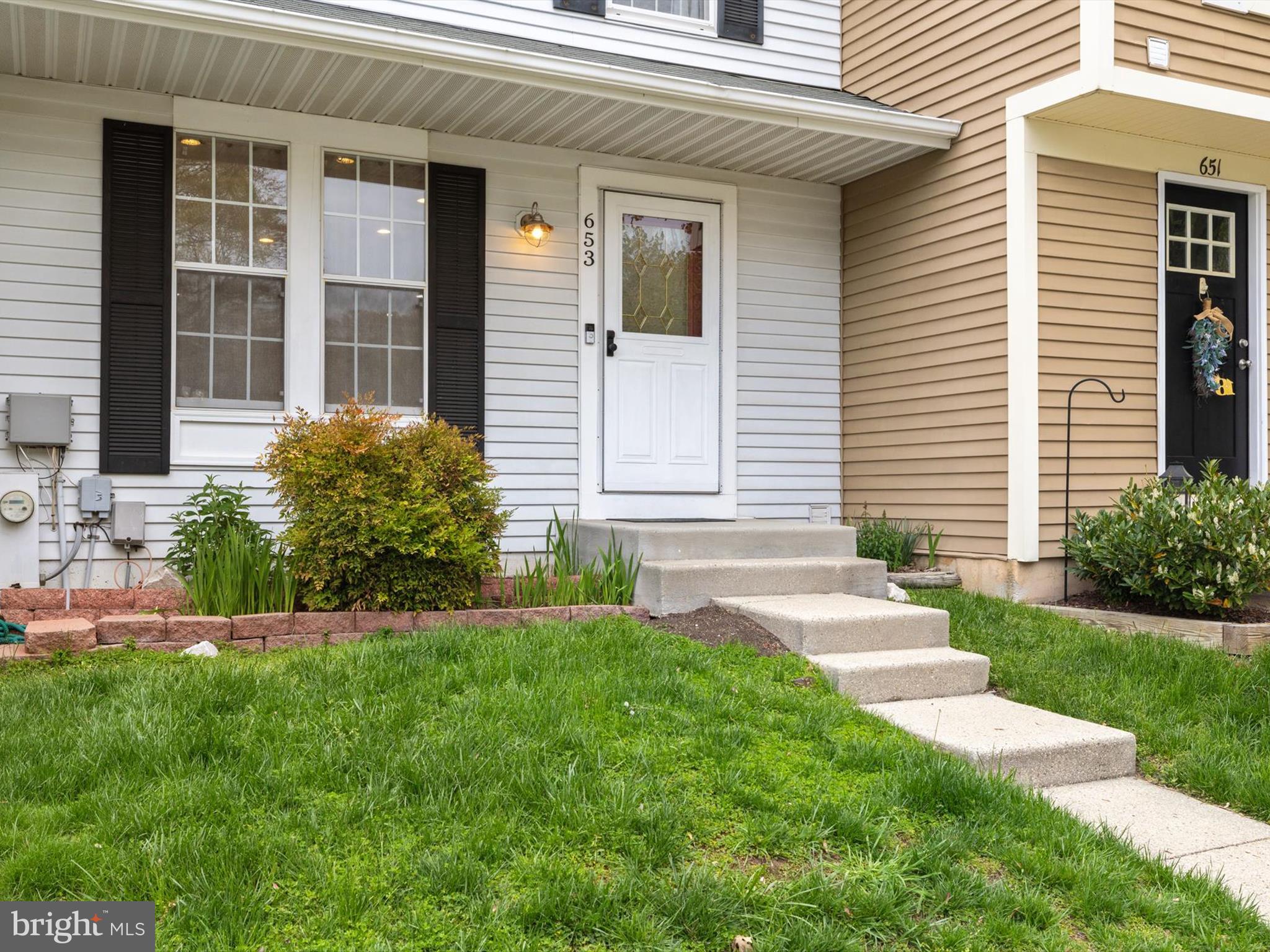 653 Willowby Run Pasadena, MD 21122 - Photo 2 of 31 a front view of a house with a yard and garage