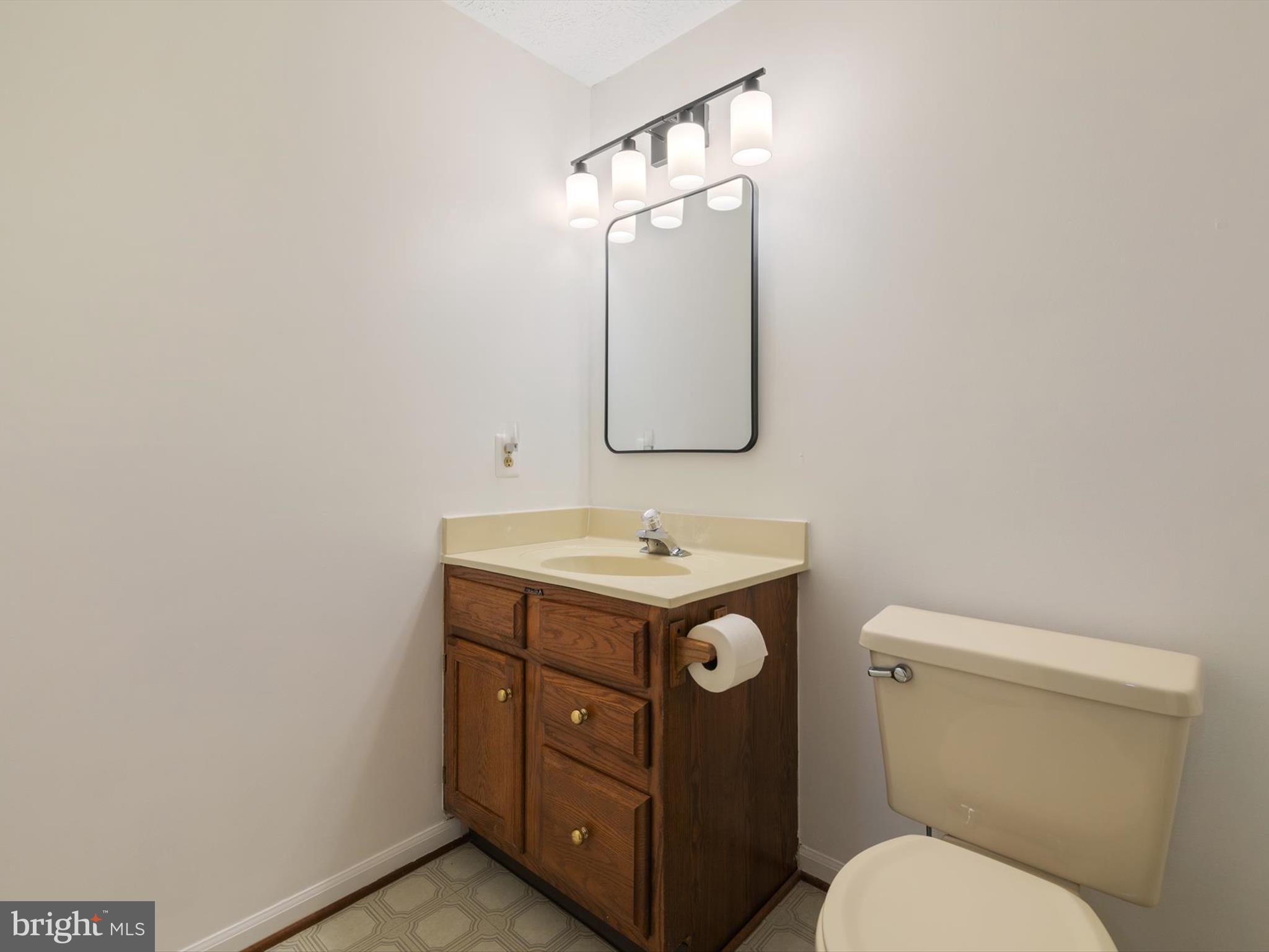 653 Willowby Run Pasadena, MD 21122 - Photo 23 of 31 a bathroom with a toilet sink and mirror