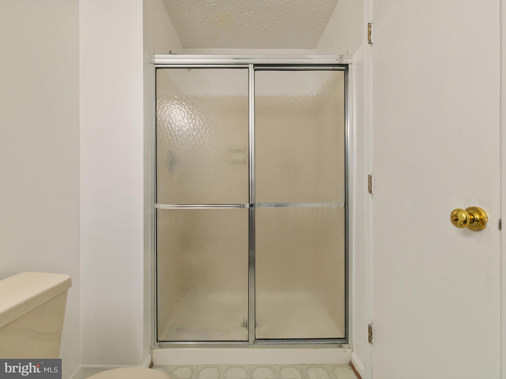 653 Willowby Run Pasadena, MD 21122 - Photo 24 of 31 a bathroom with a glass shower door