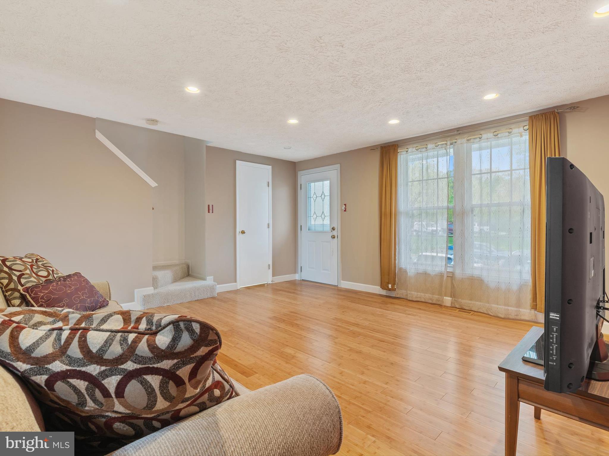 653 Willowby Run Pasadena, MD 21122 - Photo 6 of 31 a living room with a couch and a flat screen tv