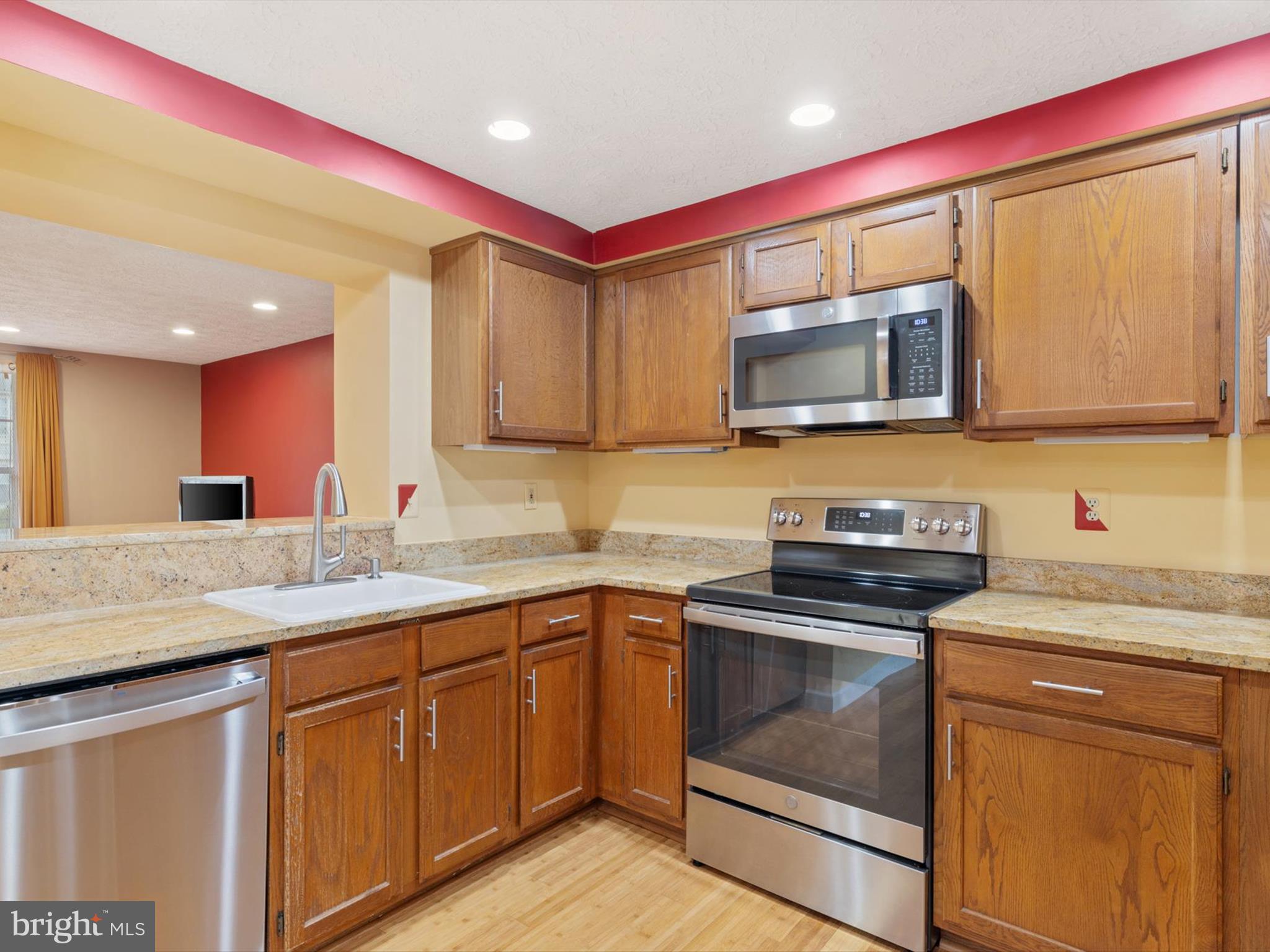 653 Willowby Run Pasadena, MD 21122 - Photo 9 of 31 a kitchen with stainless steel appliances granite countertop a sink and a microwave