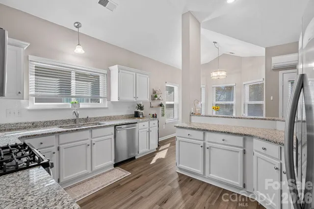 a kitchen with a refrigerator and a sink