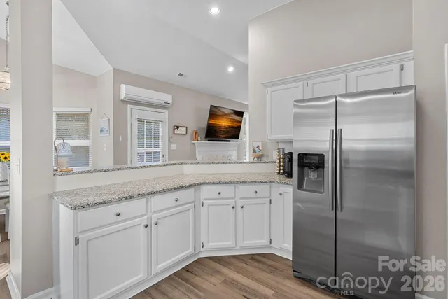 a living room with furniture a rug and a wall painting