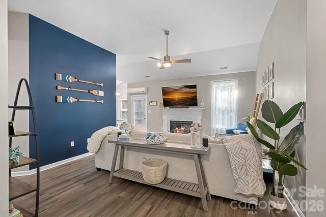 a living room with furniture a fireplace and a flat screen tv