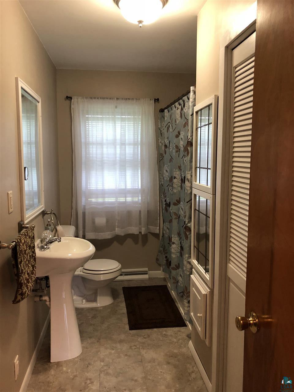 Updated flooring, tub, & pedestal sink