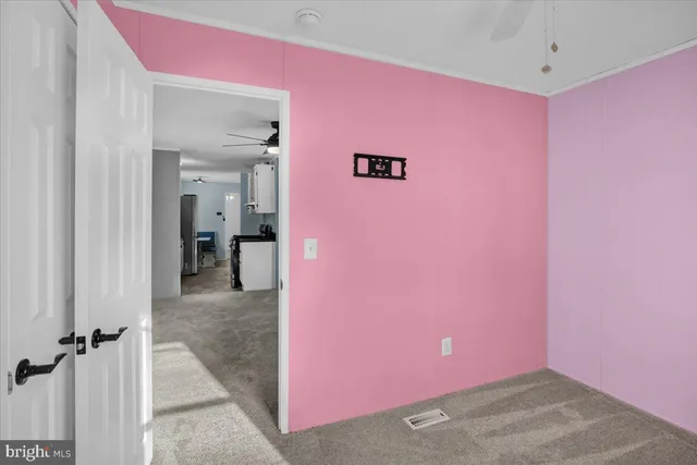 a view of a livingroom with an empty space and a window