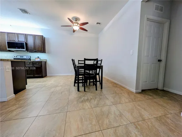 a view of a kitchen with microwave and cabinets