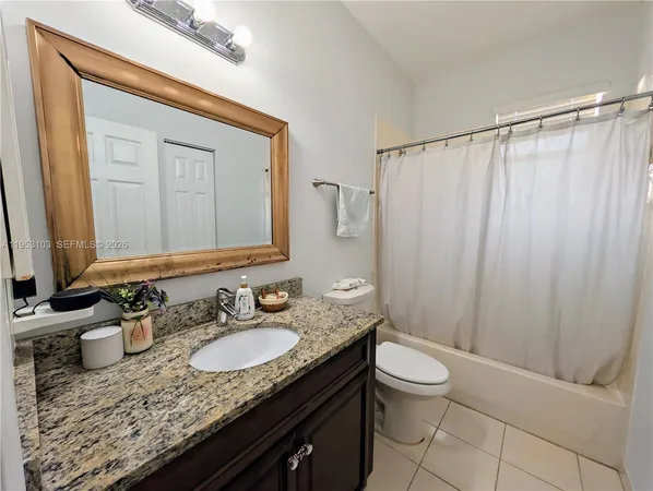 a bathroom with a toilet a sink and a mirror