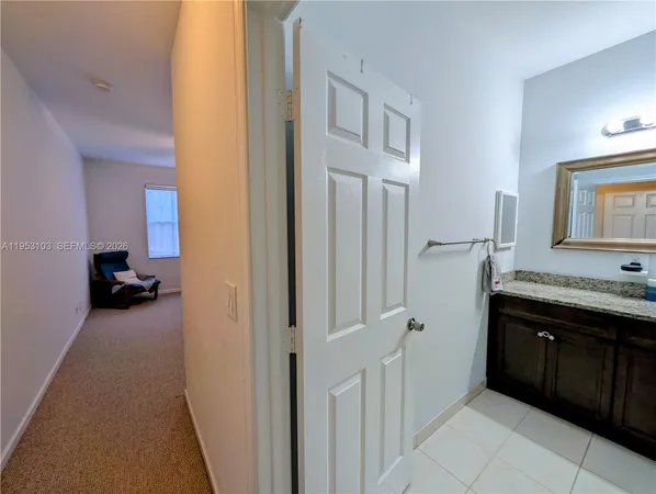 a bathroom with a granite countertop sink a toilet a mirror and shower