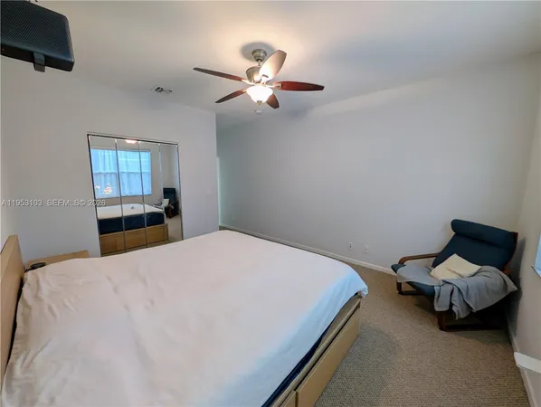 a living room with furniture kitchen view and a chandelier