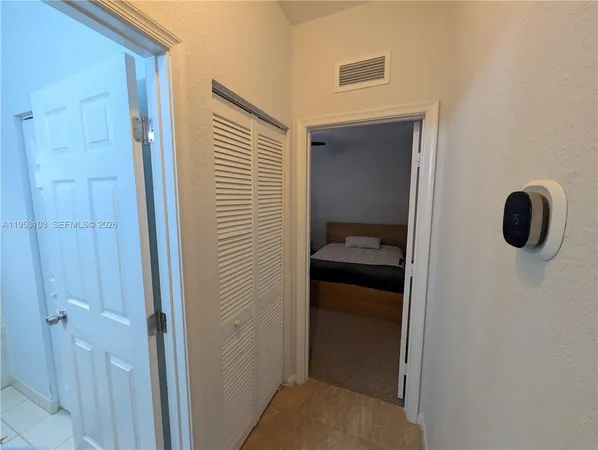 a bed room with a bed and a chair