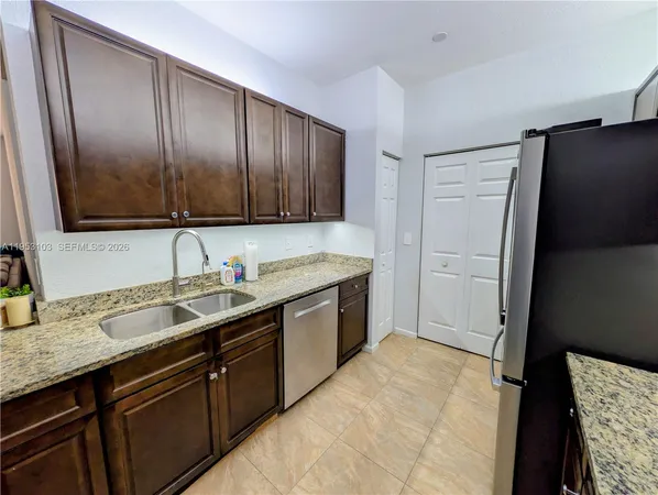 a kitchen with a sink stove and refrigerator