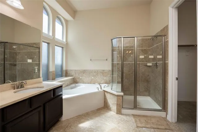 a bathroom with a double vanity sink mirror and shower