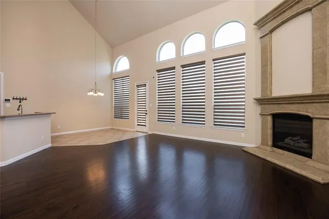 a view of a livingroom with wooden floor and a fireplace