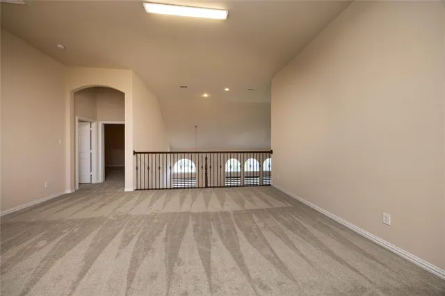 a view of a room with wooden floor and white walls