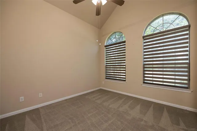 an empty room with windows and entrance