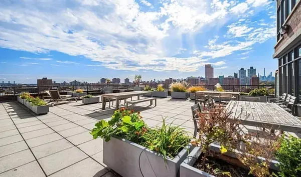 a view of a terrace with furniture and a fire pit