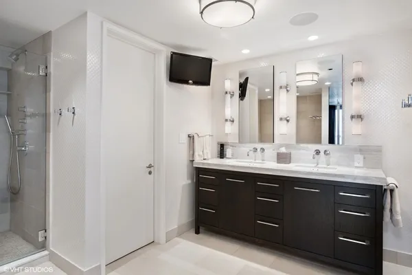 a bathroom with a granite countertop toilet sink and mirror