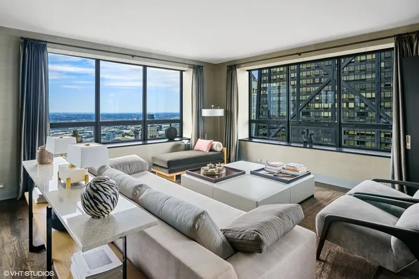 a living room with furniture a rug and a window