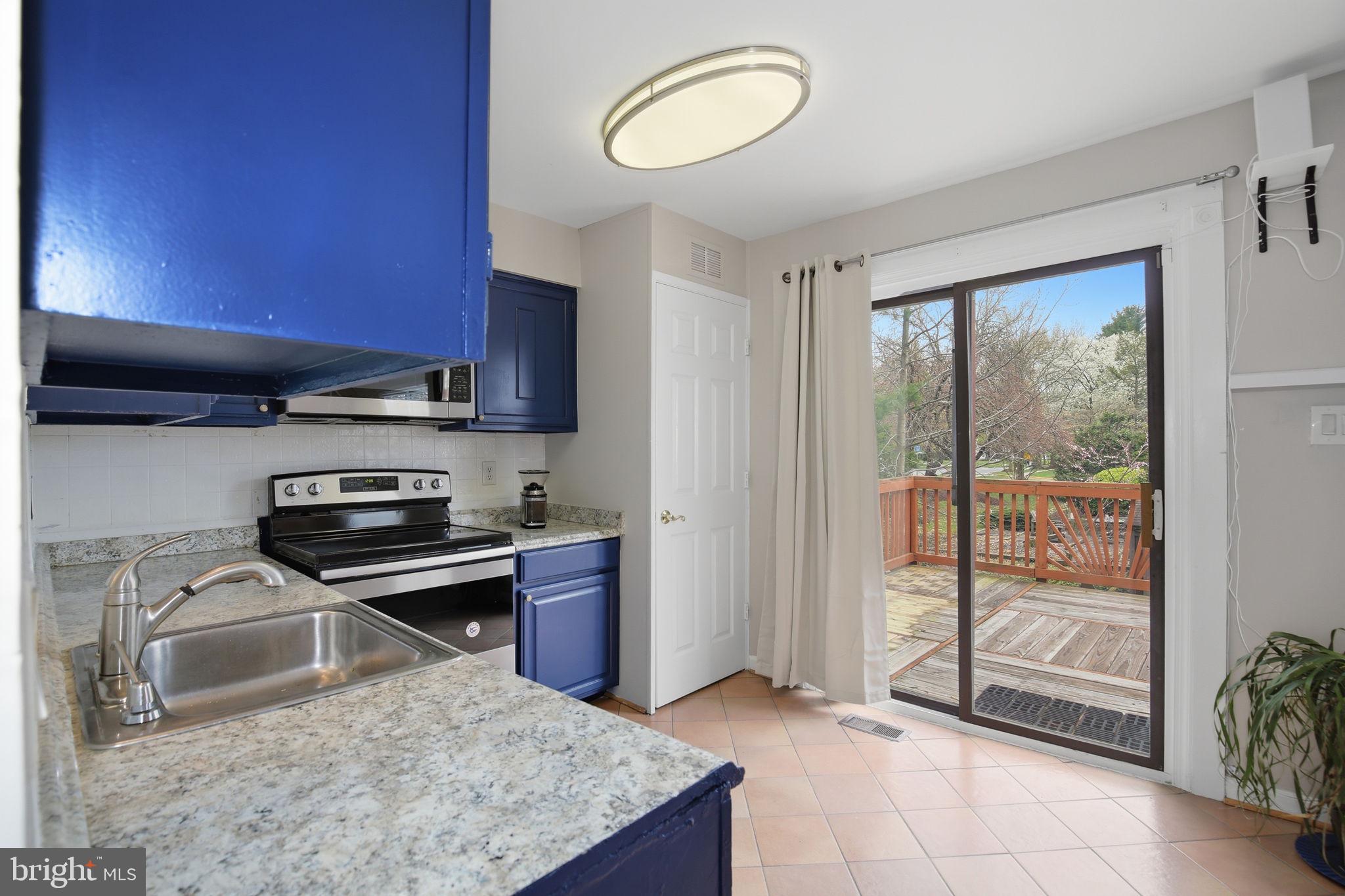 9087 Centerway Road Gaithersburg, MD 20879 - Photo 21 of 55 kitchen - sliding doors to expansive deck
