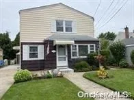 a view of house with a yard and potted plants