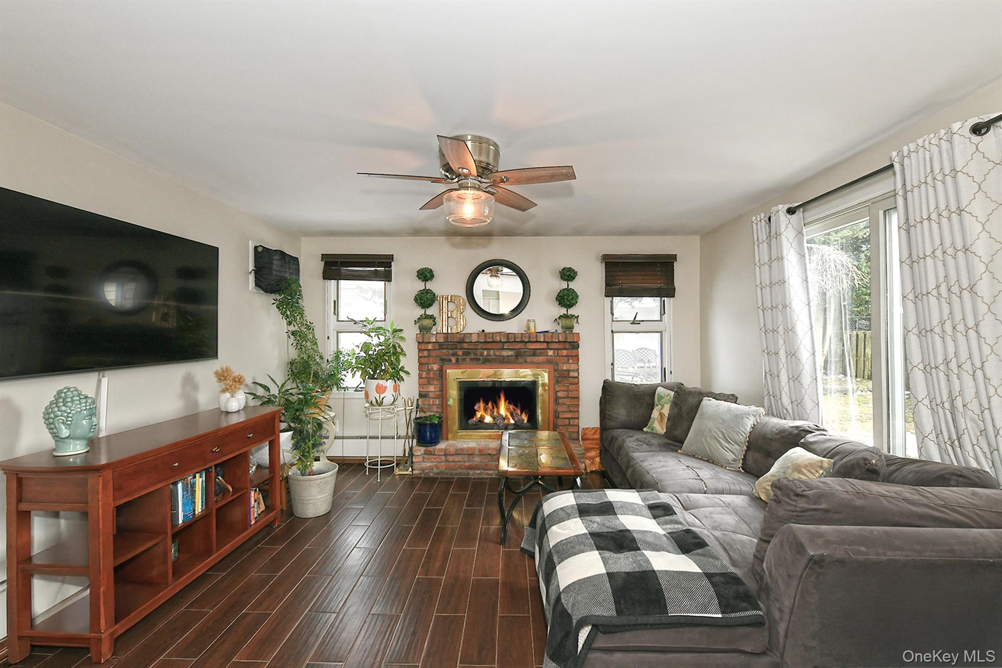 103 Ranch Lane Levittown, NY 11756 - Photo 12 of 29 a living room with furniture a flat screen tv and a fireplace