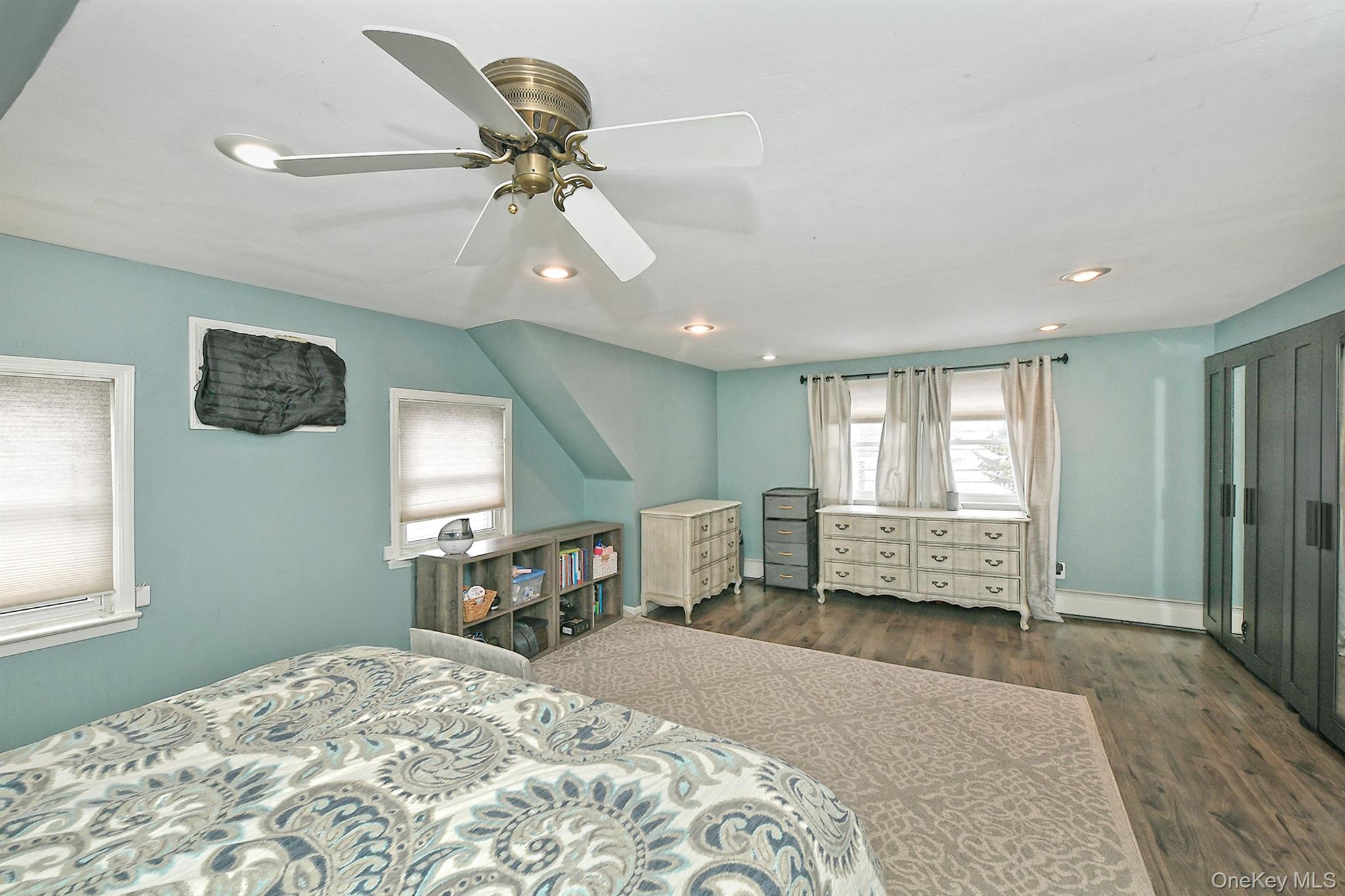 103 Ranch Lane Levittown, NY 11756 - Photo 18 of 29 a bedroom with a bed and a chandelier