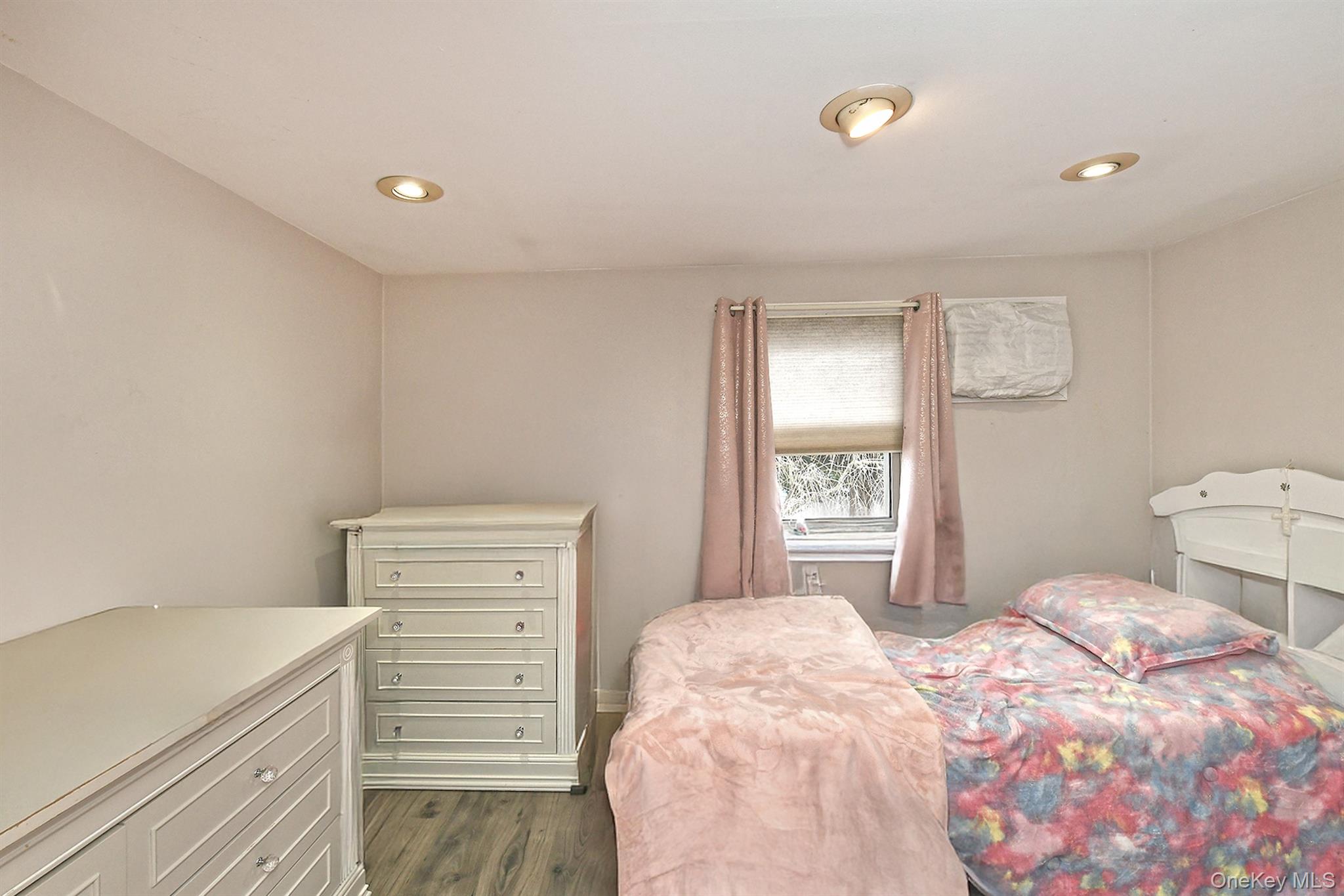 103 Ranch Lane Levittown, NY 11756 - Photo 19 of 29 a bedroom with a bed and a window