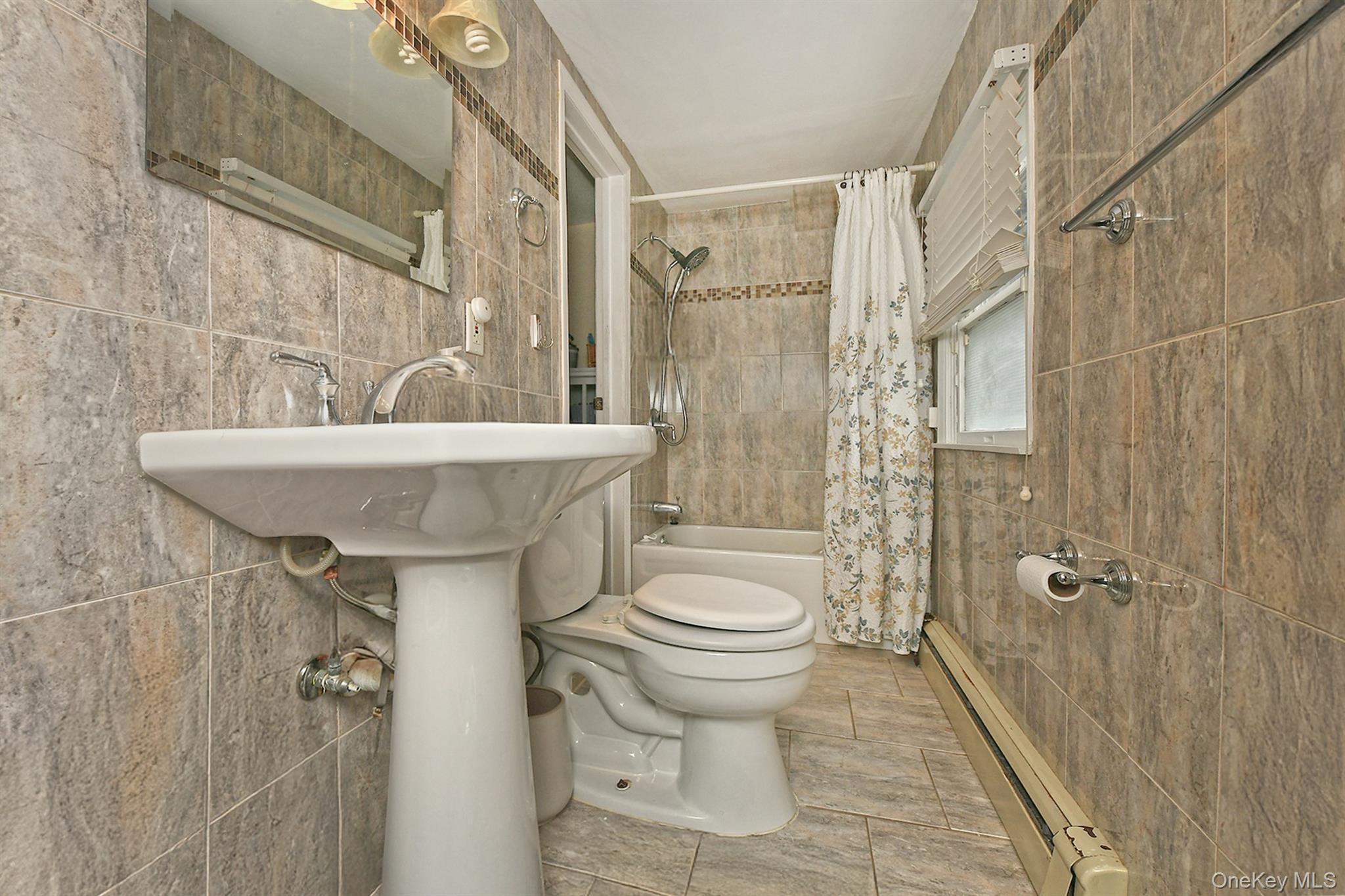 103 Ranch Lane Levittown, NY 11756 - Photo 20 of 29 a bathroom with a sink a toilet and shower