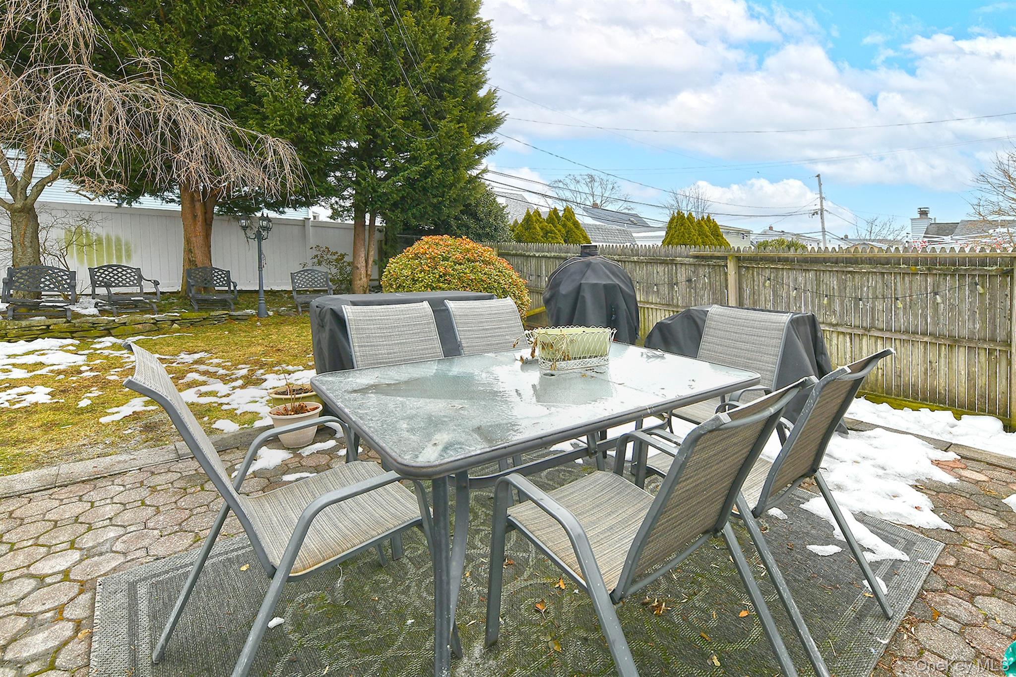 103 Ranch Lane Levittown, NY 11756 - Photo 21 of 29 a view of a patio with table and chairs and wooden floor