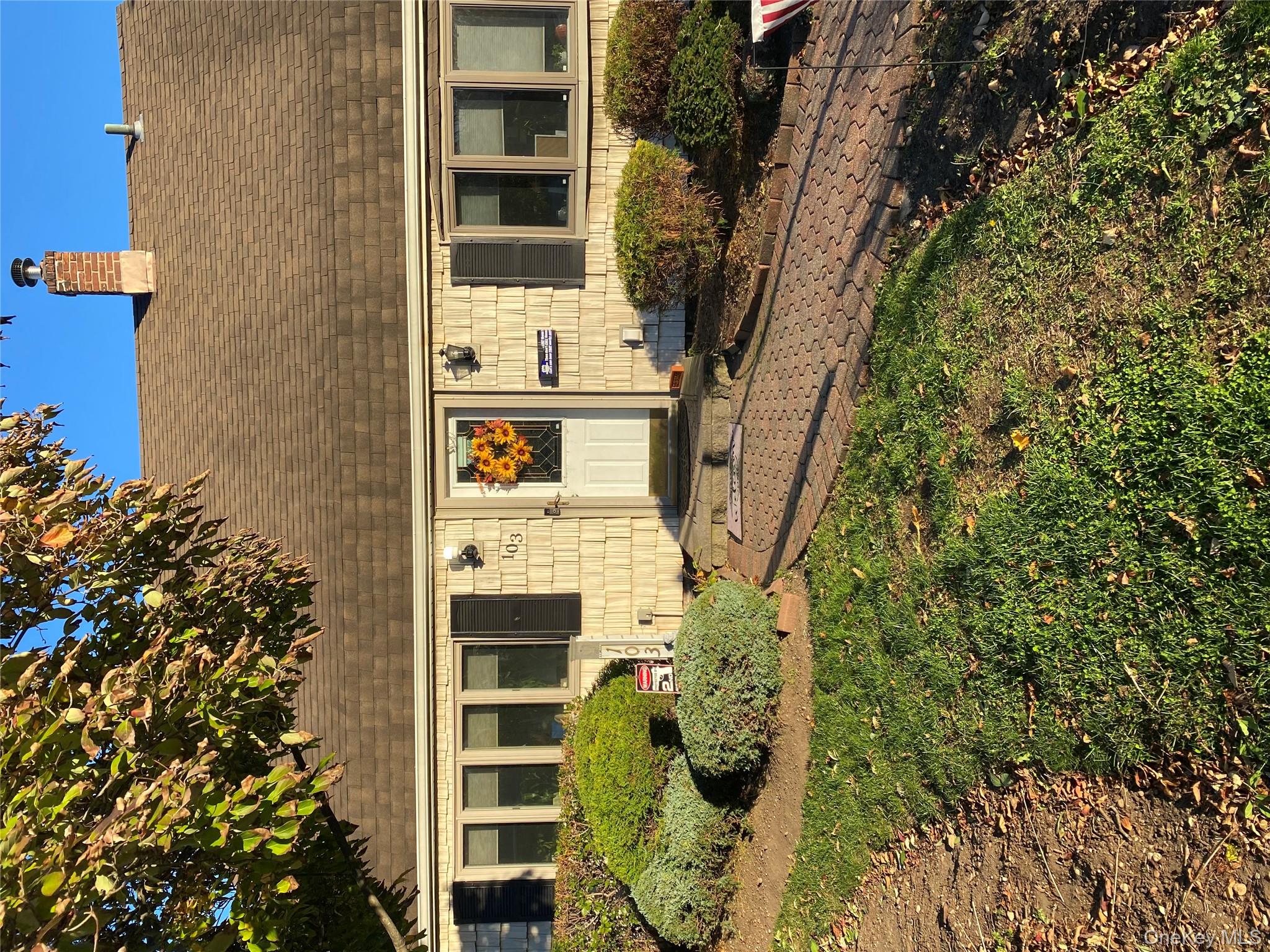 103 Ranch Lane Levittown, NY 11756 - Photo 26 of 29 a front view of a house with a yard