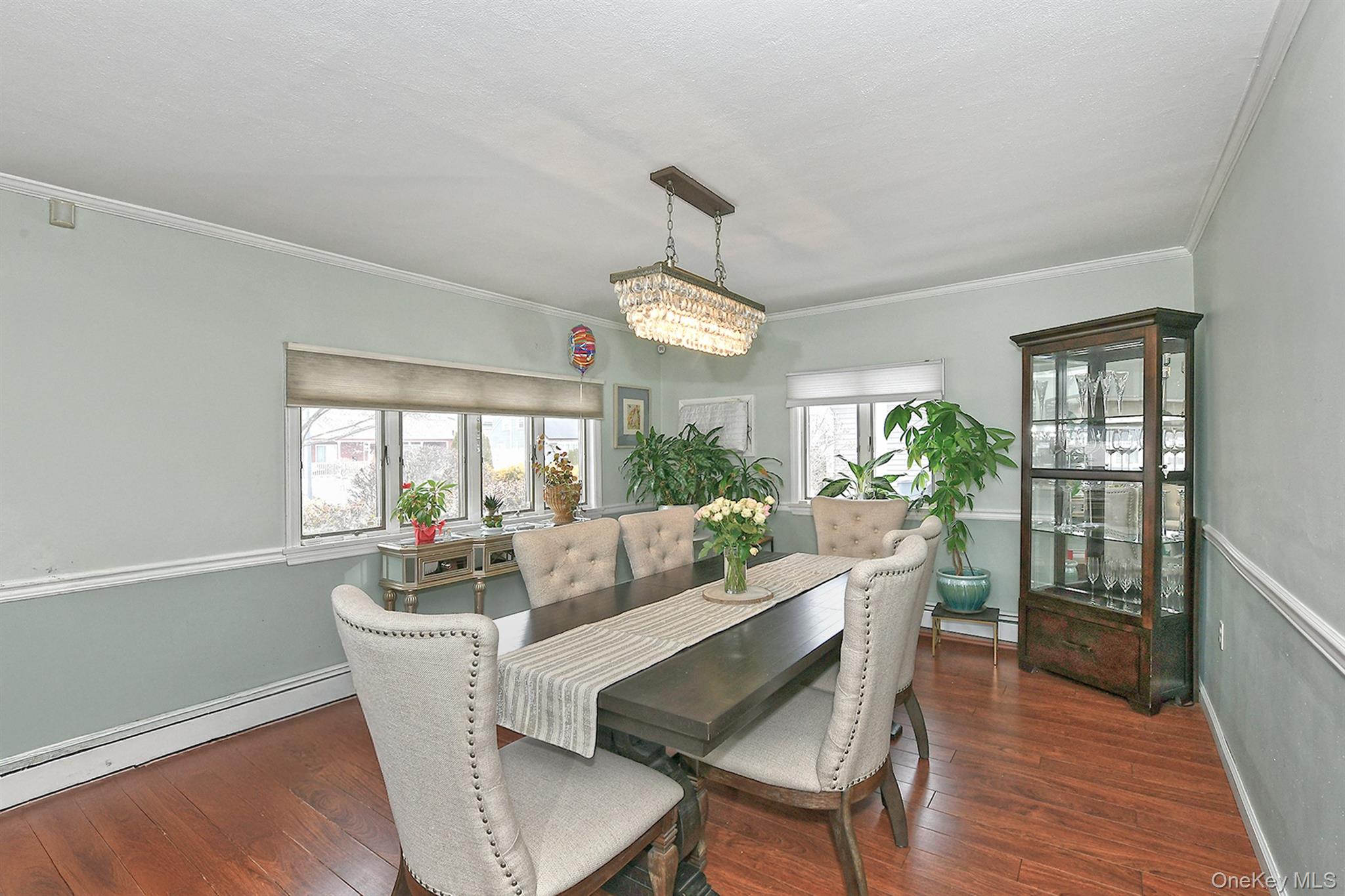 103 Ranch Lane Levittown, NY 11756 - Photo 6 of 29 a dining room with furniture a chandelier and wooden floor