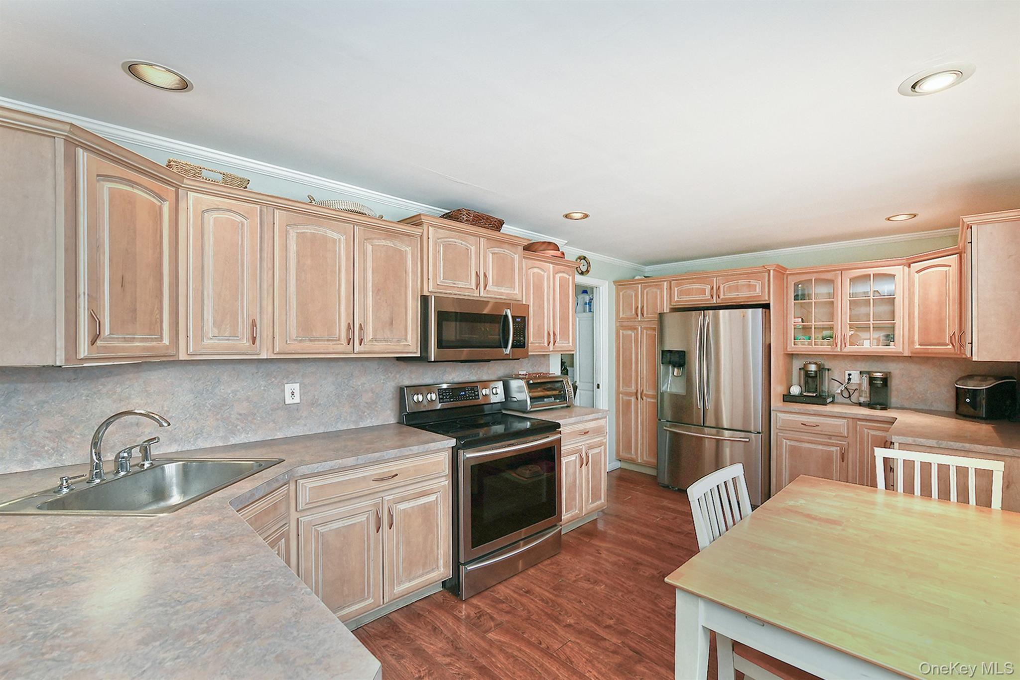 103 Ranch Lane Levittown, NY 11756 - Photo 7 of 29 a kitchen with stainless steel appliances granite countertop a refrigerator a stove top oven a sink and dishwasher