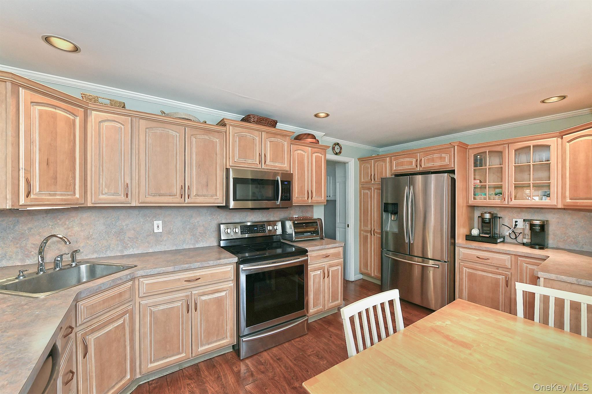 103 Ranch Lane Levittown, NY 11756 - Photo 8 of 29 a kitchen with stainless steel appliances a refrigerator stove and sink