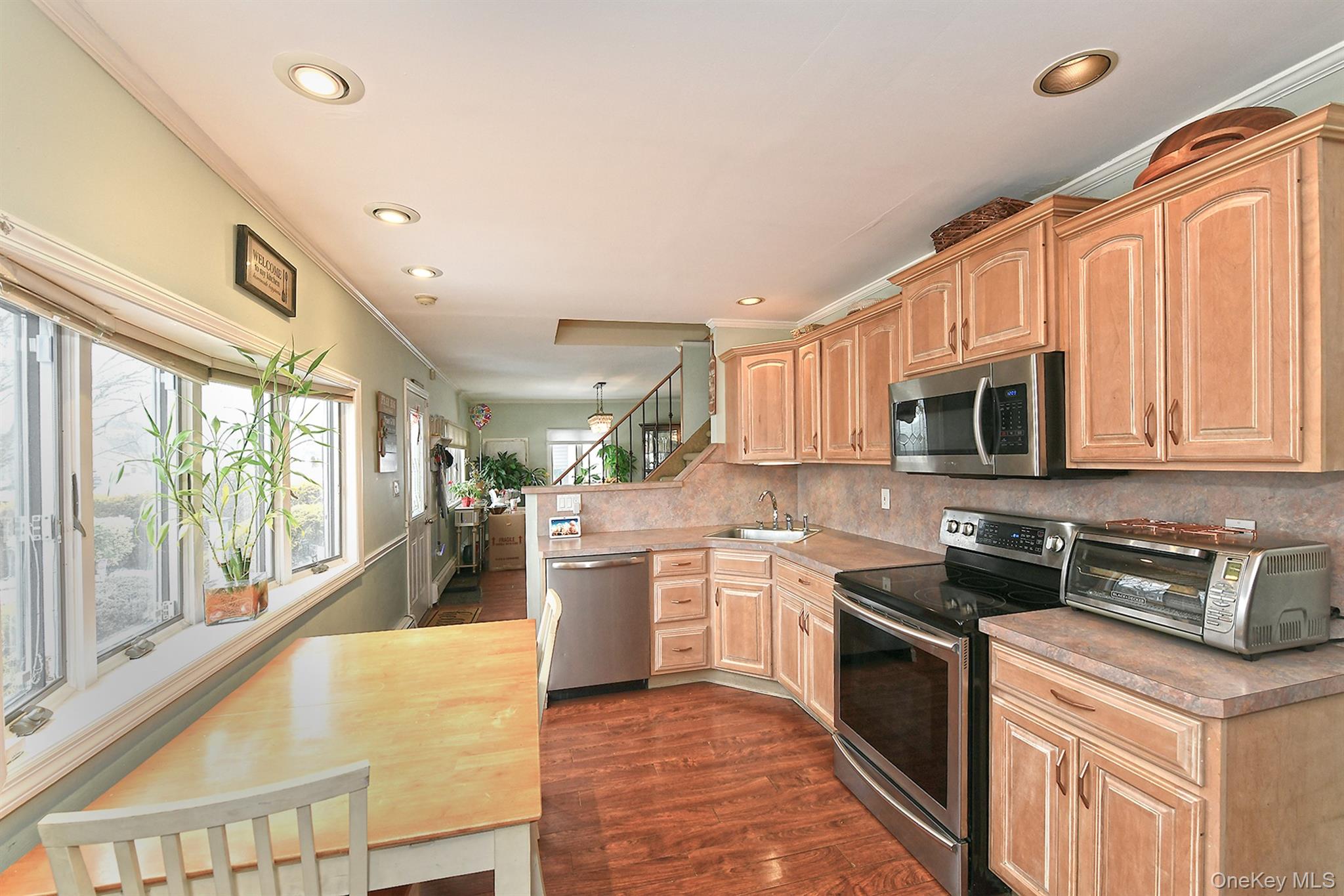 103 Ranch Lane Levittown, NY 11756 - Photo 9 of 29 a large kitchen with stainless steel appliances granite countertop a stove a sink and a refrigerator