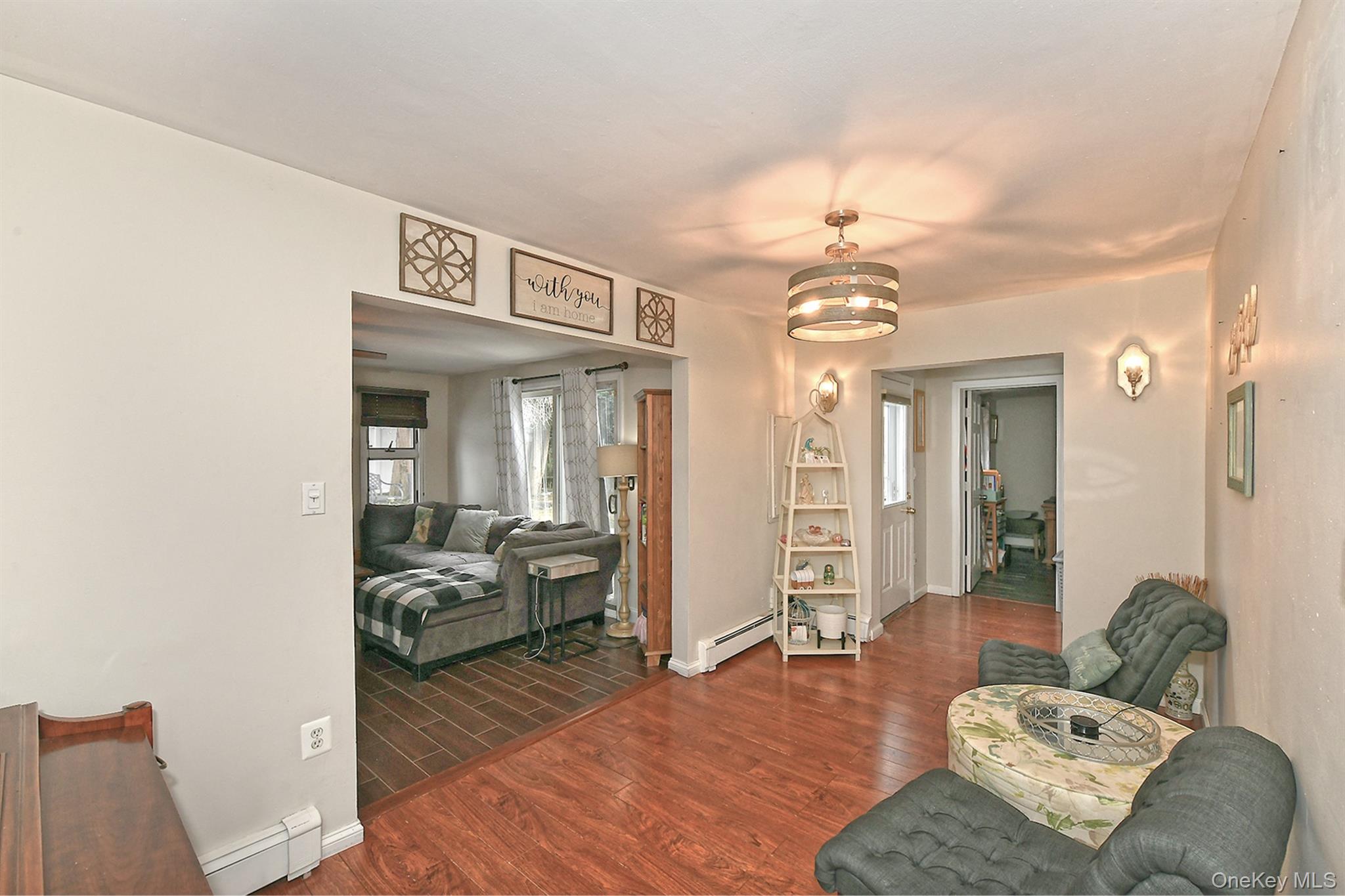 103 Ranch Lane Levittown, NY 11756 - Photo 10 of 29 a living room with furniture and a chandelier