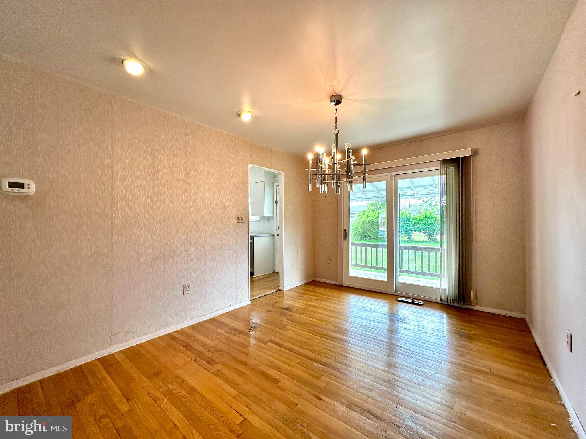 3916 Carthage Road Randallstown, MD 21133 - Photo 20 of 52 a view of an empty room with wooden floor and a window