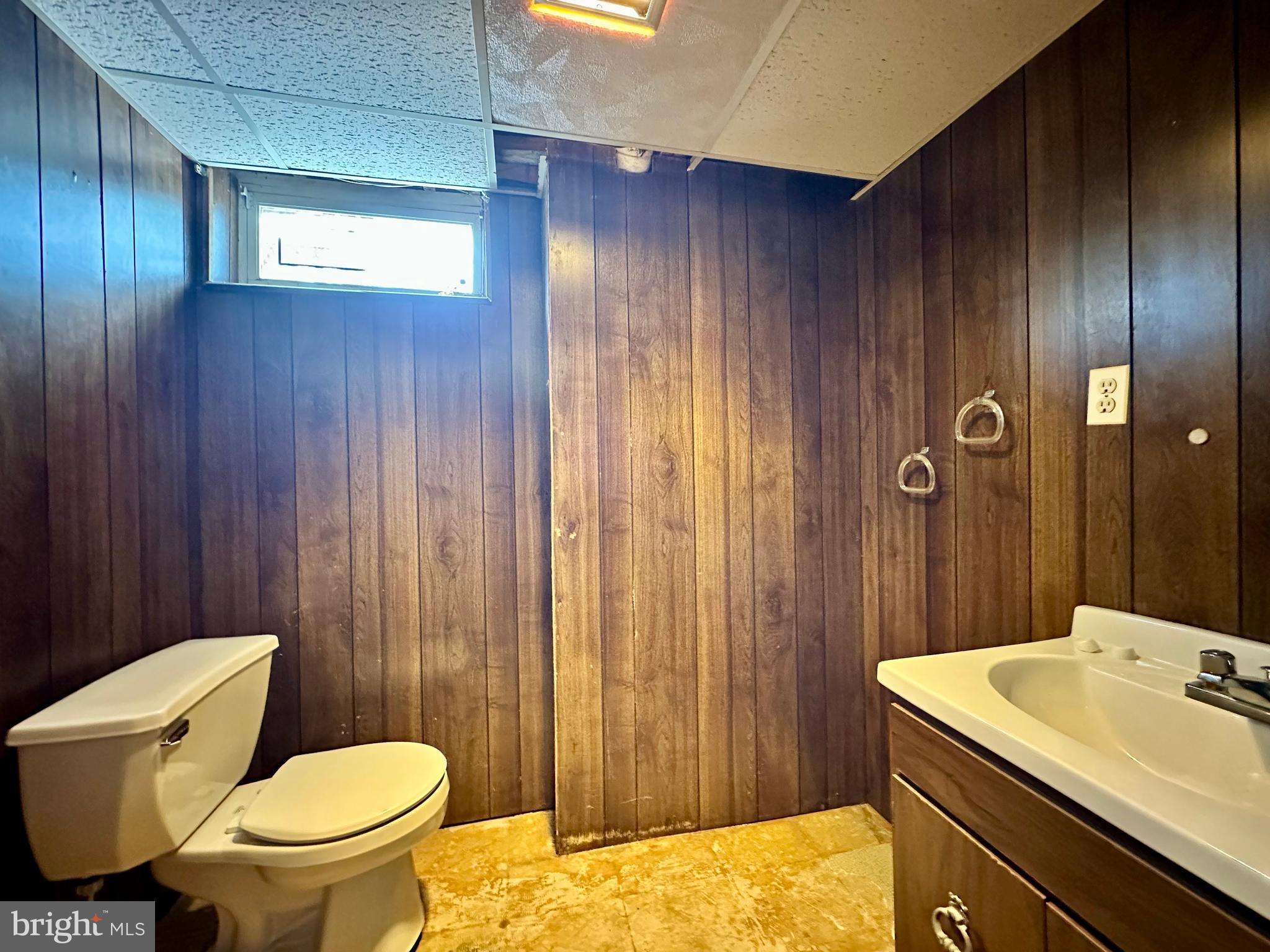 3916 Carthage Road Randallstown, MD 21133 - Photo 47 of 52 a bathroom with a sink a toilet a mirror and shower curtain