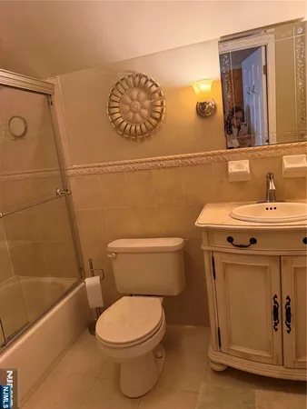 a bathroom with a toilet a sink and mirror