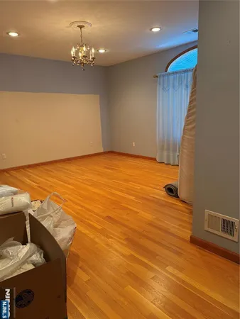 a view of a room with wooden floor