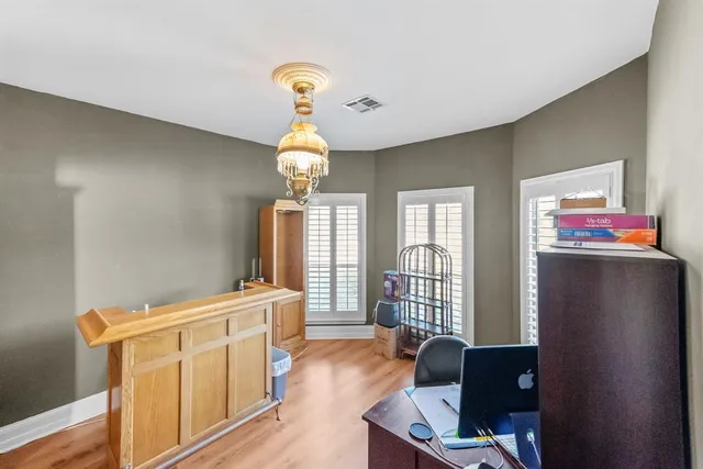 a bedroom with a bed and a chandelier