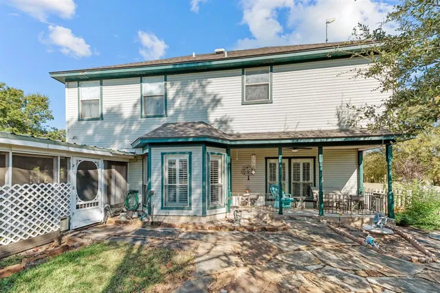 a view of a house with backyard porch and sitting area
