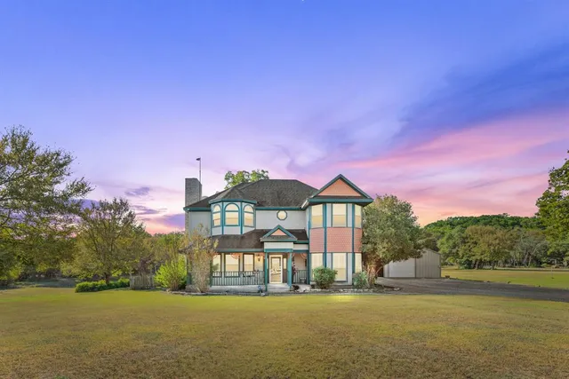 a front view of a house with a garden and a yard