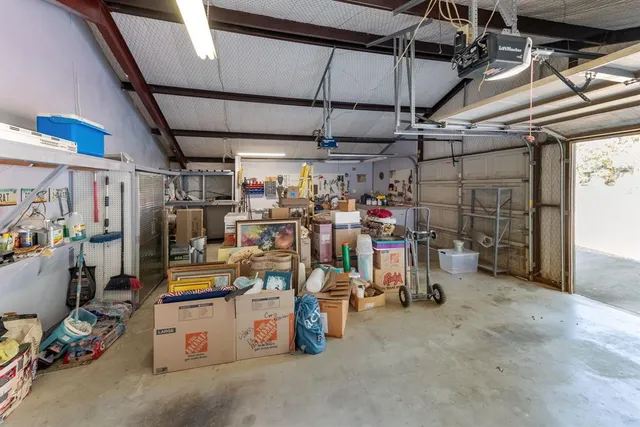 a view of a kitchen with stainless steel appliances granite countertop a sink and wooden floors