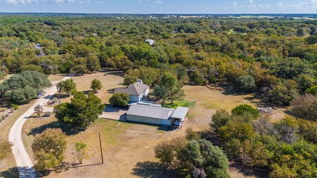 an aerial view of a house with a yard and garden