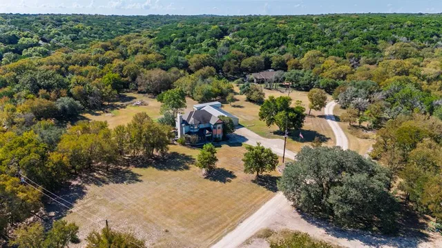 an aerial view of a house with a yard